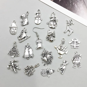 Macro shot of antique silver Christmas charms featuring Santa and reindeer for DIY jewelry