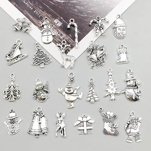Detailed close-up of vintage silver alloy Christmas pendants including Santa and snowflakes