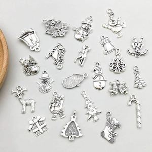 Detail shot of antique silver Christmas charms including Santa, reindeer and tree