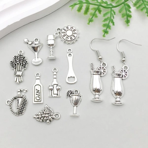 Detailed macro shot of vintage silver wine and beer themed alloy charms for DIY jewelry making