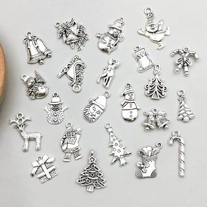 Detailed flat lay of antique silver Christmas charms featuring Santa and reindeer motifs