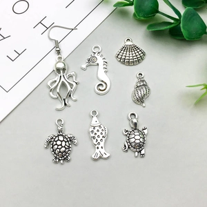 Detail view of antique silver marine alloy charms like seahorse and octopus for DIY jewelry