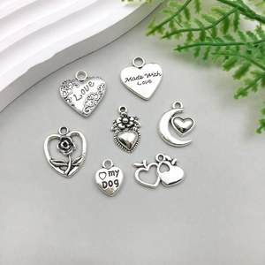 Macro shot of seven antique silver heart pendants for DIY jewelry crafting projects