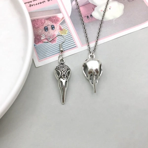 Gothic style antique silver bird skull pendant and earring set with dark vintage engraving