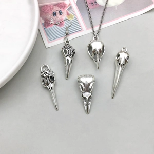 Antique silver bird skull jewelry set with filigree carvings and vintage gothic pendants