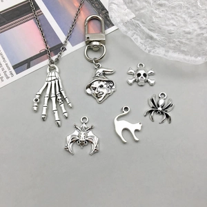 Macro view of vintage silver alloy Halloween charms including bat, spider and skull motifs