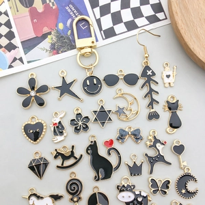 Detailed flat lay of black enamel alloy animal charms and DIY jewelry accessories
