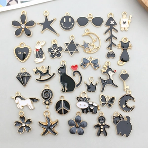 Detailed assortment of black enamel and gold alloy animal charms for DIY jewelry making