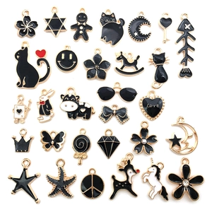 Assorted black enamel alloy pendants featuring animals and stars with gold plating