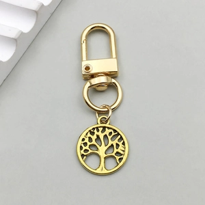 Detailed view of champagne gold tree of life pendant with lobster clasp and D-ring