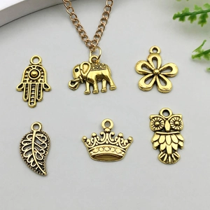 Antique gold alloy pendants set featuring vintage leaf, butterfly, and crown designs