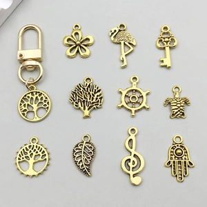 Detailed set of vintage gold alloy pendants featuring butterfly and leaf for DIY jewelry