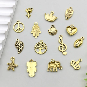Variety of vintage gold alloy charms including butterfly, crown and leaf for DIY jewelry