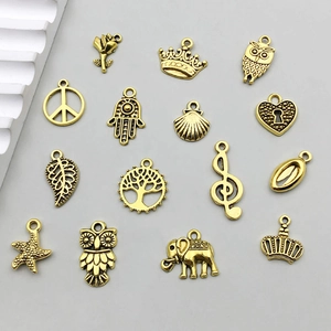 Vintage gold alloy pendant charms set featuring butterfly, leaves, and crown for DIY jewelry
