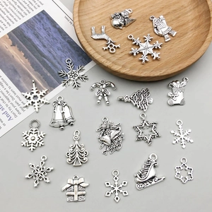 Detailed view of antique silver Christmas charms including snowflakes and reindeer for DIY jewelry