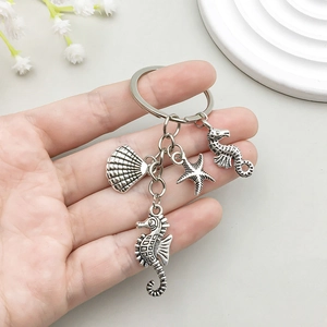 Vintage silver ocean keychain featuring detailed seahorse, starfish and seashell charms