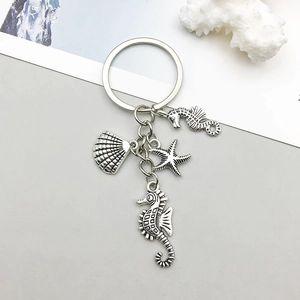 Detailed view of silver alloy seahorse, starfish and shell ocean theme keychains