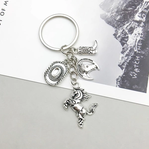 Detailed view of vintage silver Western cowboy charms featuring horse, hat, and boot pendants