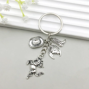 Detailed macro of vintage silver cowboy hat and western charms on a metal keychain