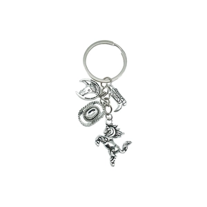 Antique silver cowboy keychain with horse, horseshoe, boot and hat pendants on white background