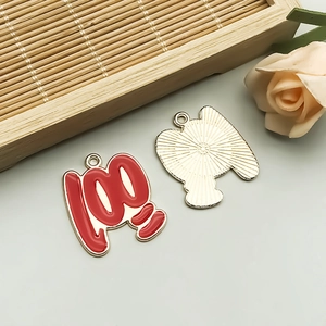 Macro view of red enamel number 100 alloy charms for DIY necklaces and bracelets