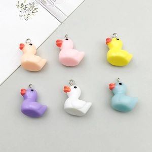 Detailed view of colorful resin duck charms for DIY bracelets with metal rings