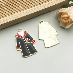 Detail of colorful enamel graduation gown pendants with intricate gold back textures