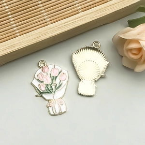 Detail of tulip flower enamel pendant with gold finish back and top hanging loop