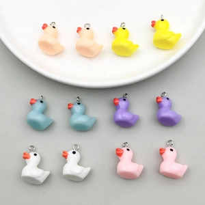 Macro view of colorful resin duck pendants for DIY jewelry making in six vibrant colors