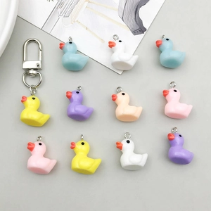 Macro detail of colorful resin mini duck charms for DIY bracelets with metal rings