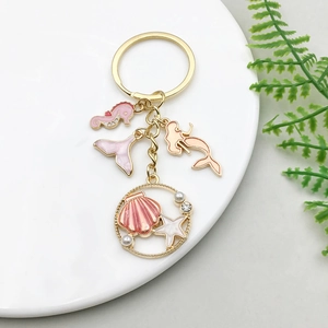 Golden mermaid and seahorse keychain with pink enamel charms and sea shell pendants