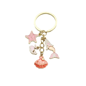 Porte-clés sirène et étoile de mer dorés avec breloques roses et gravure Summer