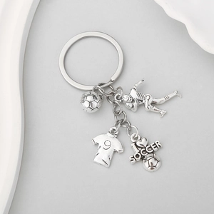 Detail view of antique silver football keychain with jersey, ball, and player charms