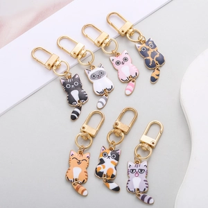 Detailed view of colorful enamel cat keychains with seven diverse patterns and gold hardware