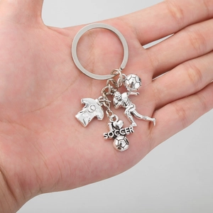 Handheld vintage silver soccer keychain featuring jersey, player, ball and heart charm