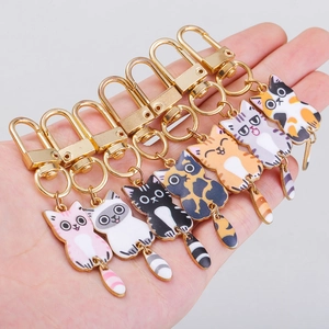 Set of 7 colorful enamel cat keychains with flexible tails in various cat breeds