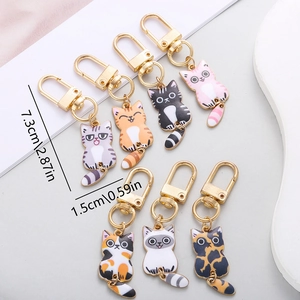 Set of colorful enamel cat alloy keychains with movable tails and dimensions shown