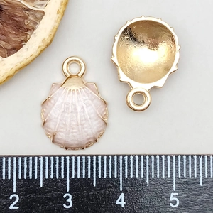 Macro detail of a 1.5cm pink shell pendant showing front enamel and golden back