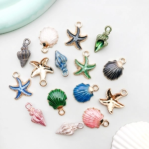 Macro shot of colorful enamel sea shell and starfish alloy charms for DIY jewelry making