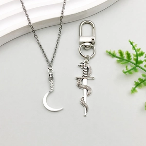Gothic silver alloy set featuring a scythe pendant necklace and snake dagger keychain charm