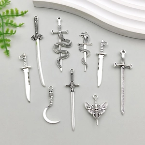 Set of nine antique silver alloy dagger and sword pendants for DIY jewelry making