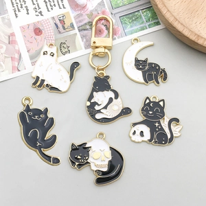 Enamel black and white Halloween cat charms in moon and ghost designs for DIY jewelry