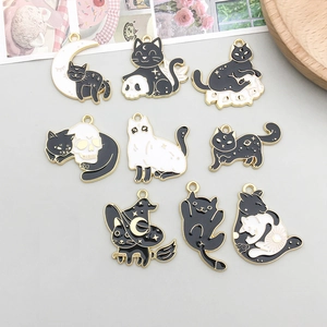 Detailed set of 9 black and white enamel cat pendants for DIY Halloween jewelry making