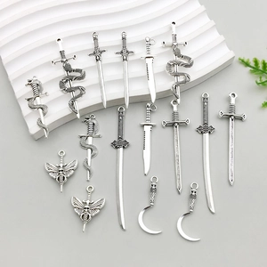 Detailed macro shot of vintage silver gothic dagger and sword pendants for DIY jewelry