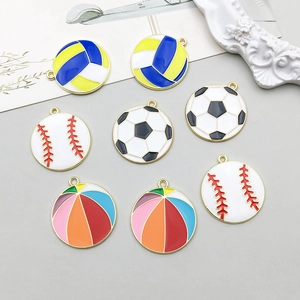 Detailed close-up of colorful enamel sports ball pendants with golden metal frames for DIY