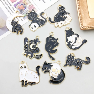 Set of 9 black and white enamel cat charms with moon and stars for Halloween jewelry making