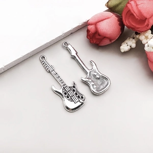 Detail view of two antique silver electric guitar pendants for DIY jewelry making