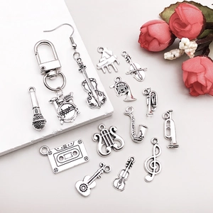 Macro view of vintage silver musical instrument charms like violin and saxophone