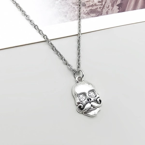Close-up of vintage silver beard skull pendant with gothic punk metal texture details