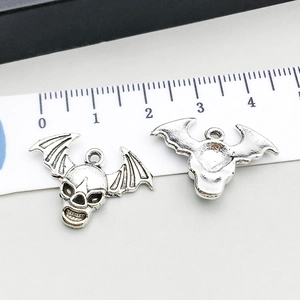 Detailed view of silver bat wing skull pendant with scale showing 3.5cm width